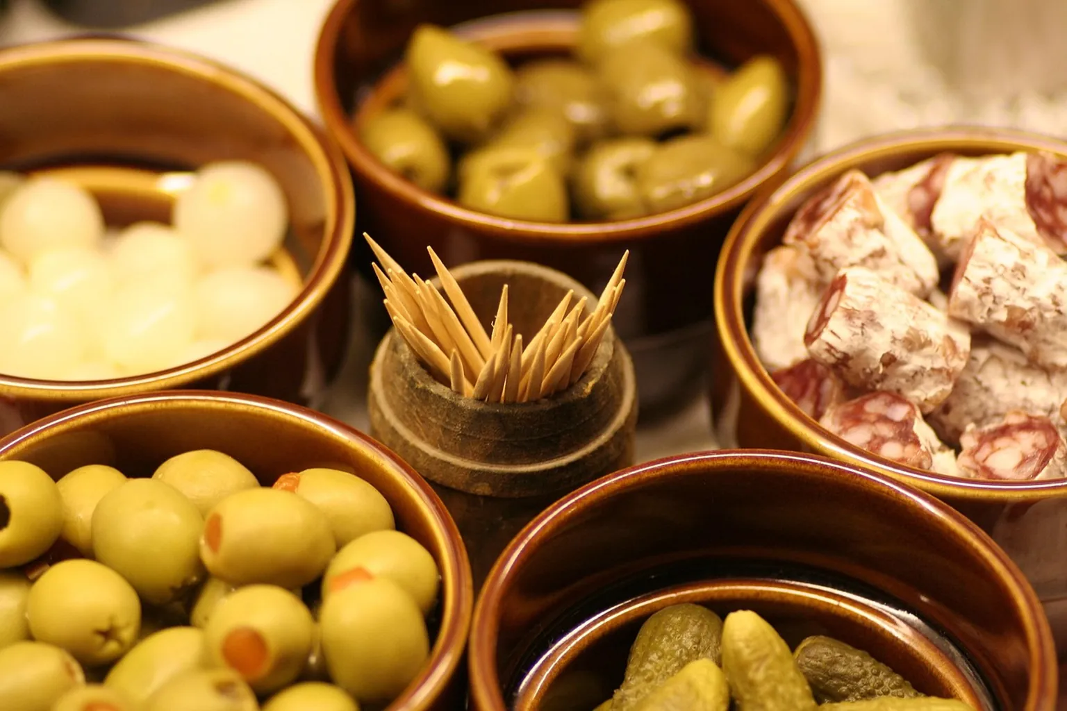Small plates of vegetables and bread on a sunlit bistro table